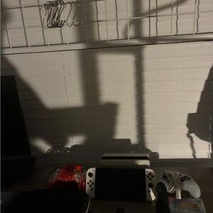 Nintendo Console with White and Black Controllers